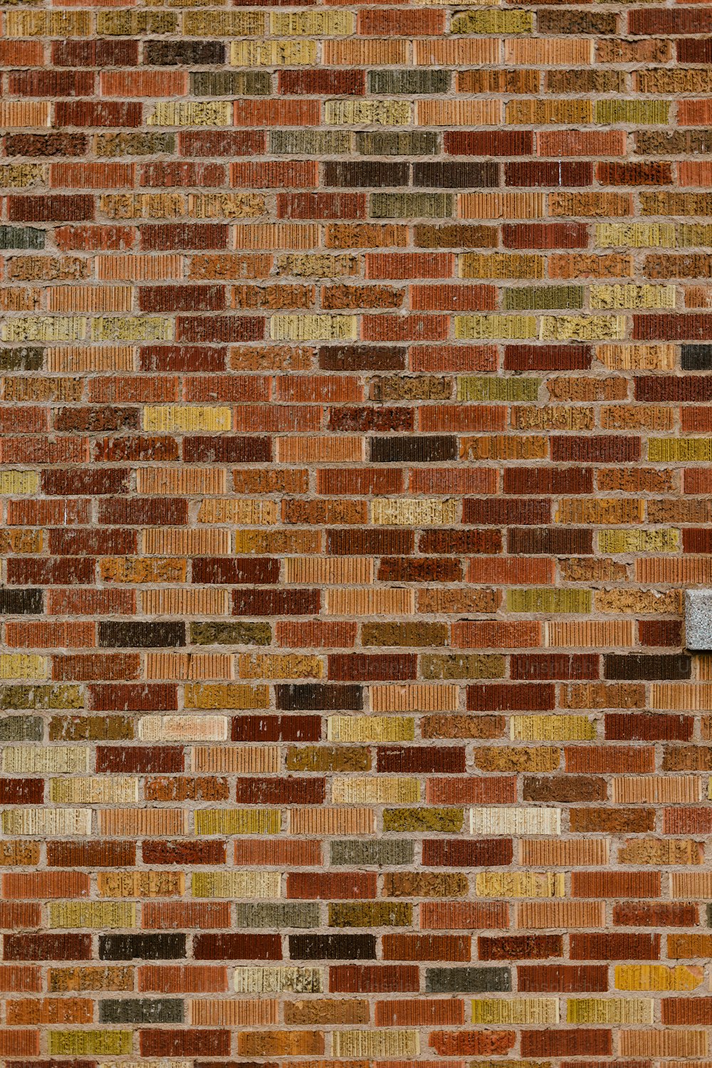 a brick wall with a clock on the side of it