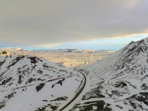 a view of a snowy mountain with a road going through it