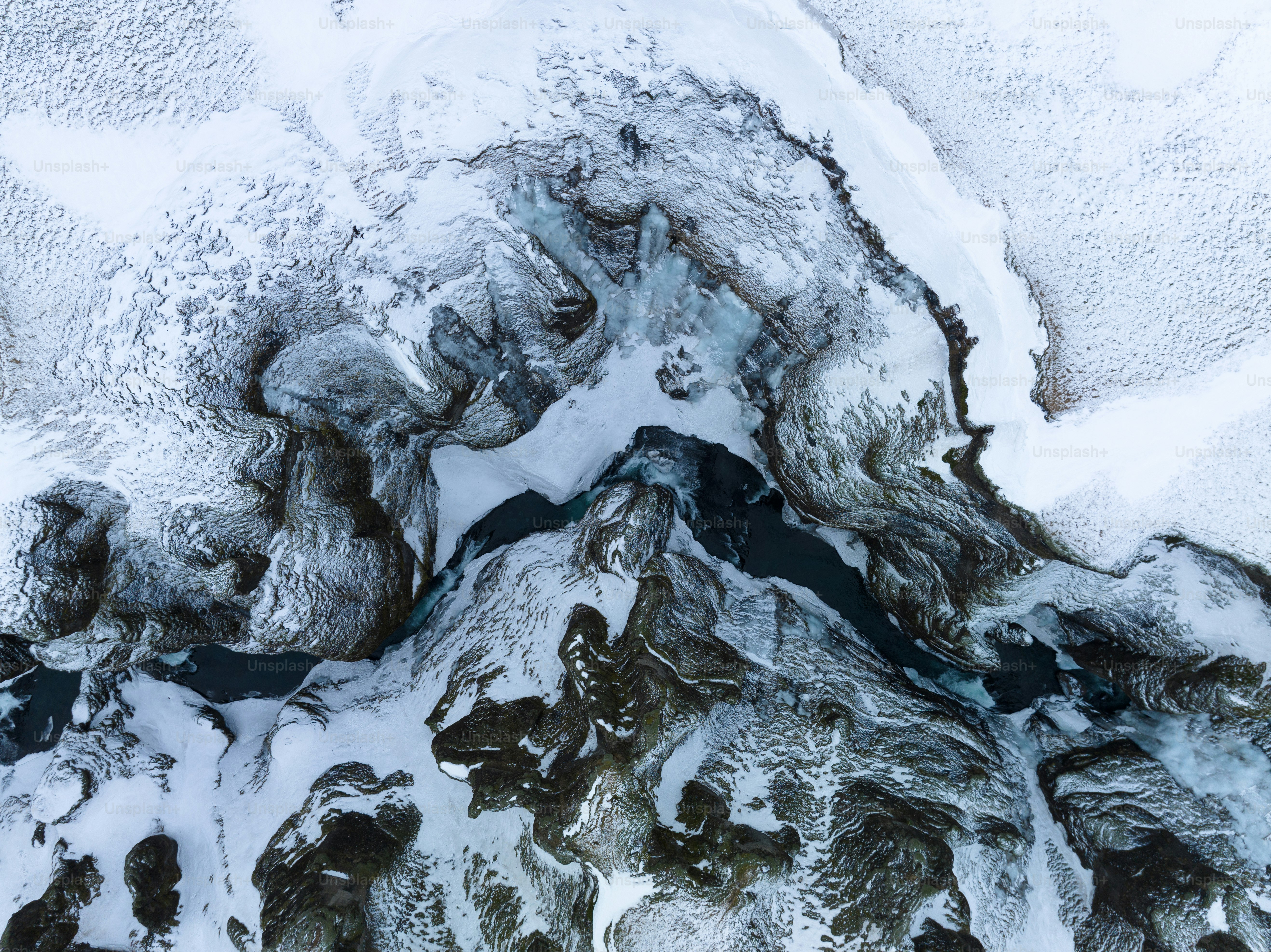 An aerial view of a snow covered mountain photo – Aerial view Image on ...