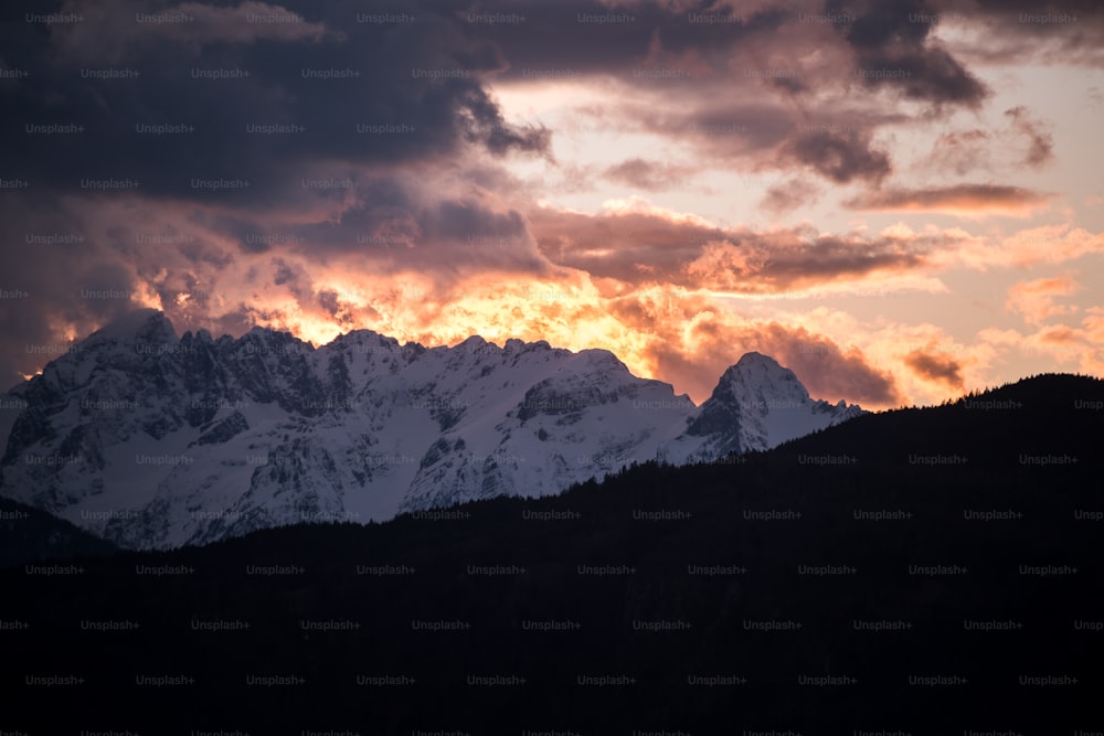 a view of a mountain range with clouds in the sky