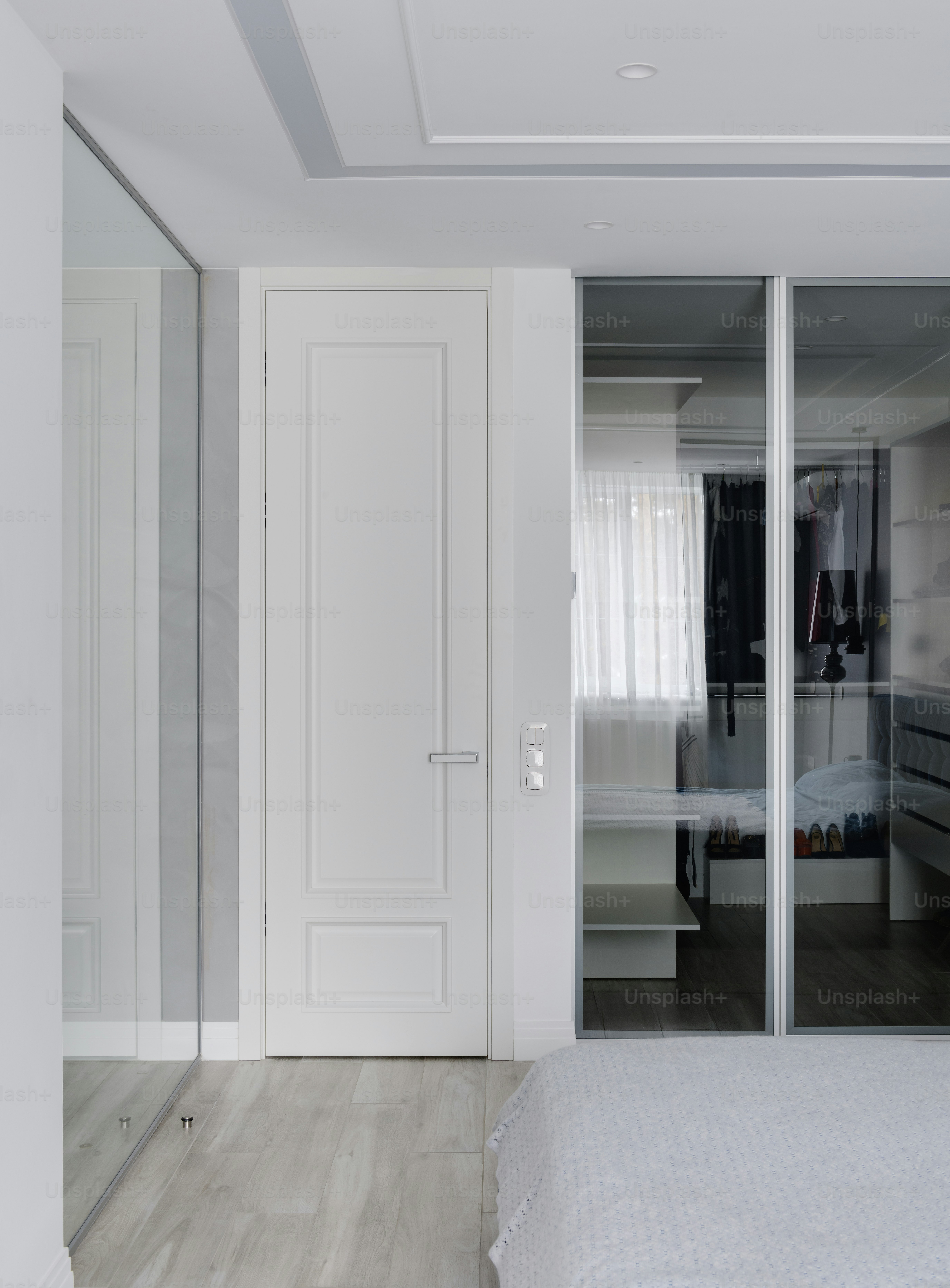 a bedroom with a bed, closet and closet doors