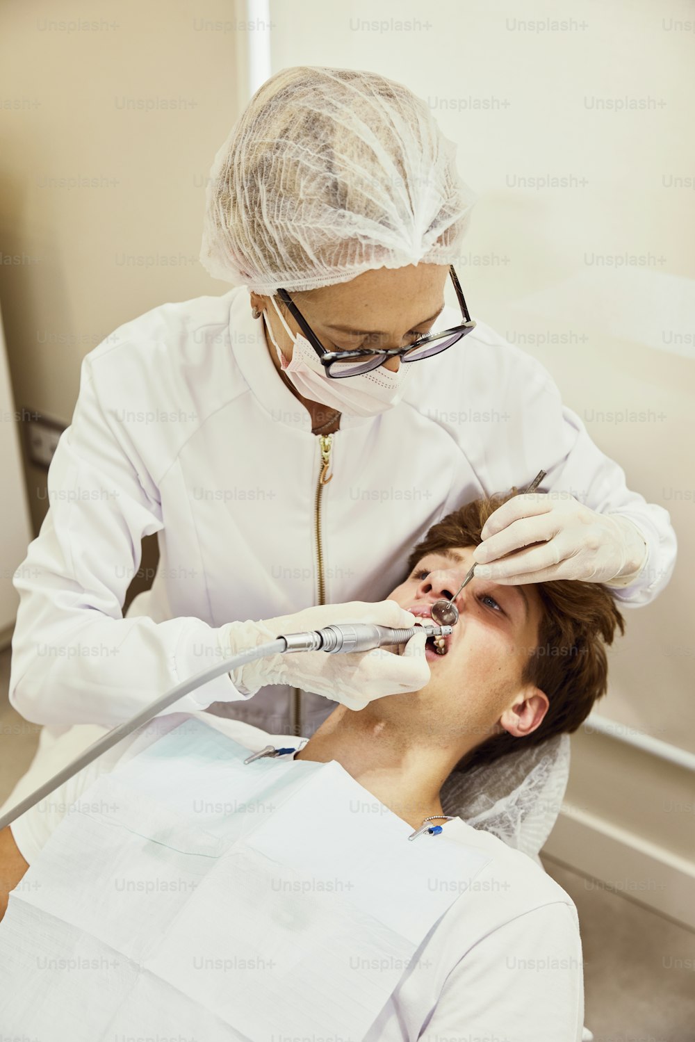 a man getting his teeth checked by a dentist