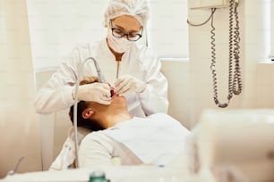 a man getting his teeth checked by a dentist