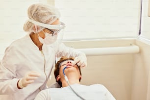 a man in a dentist chair getting his teeth checked