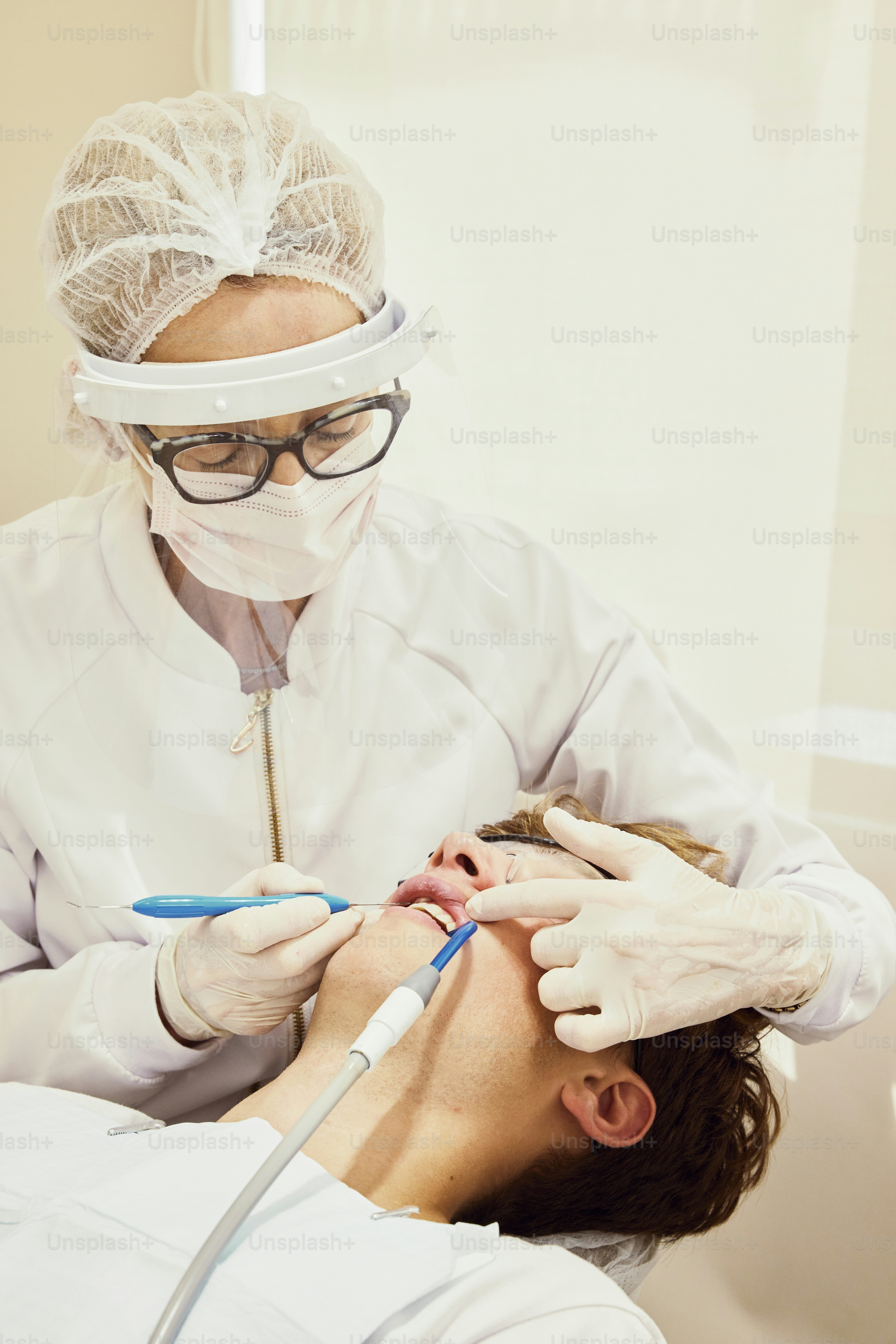 Un hombre que se hace revisar los dientes por un dentista
