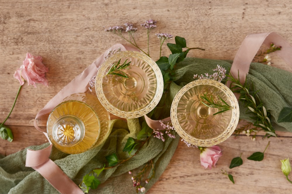 a couple of glasses sitting on top of a wooden table