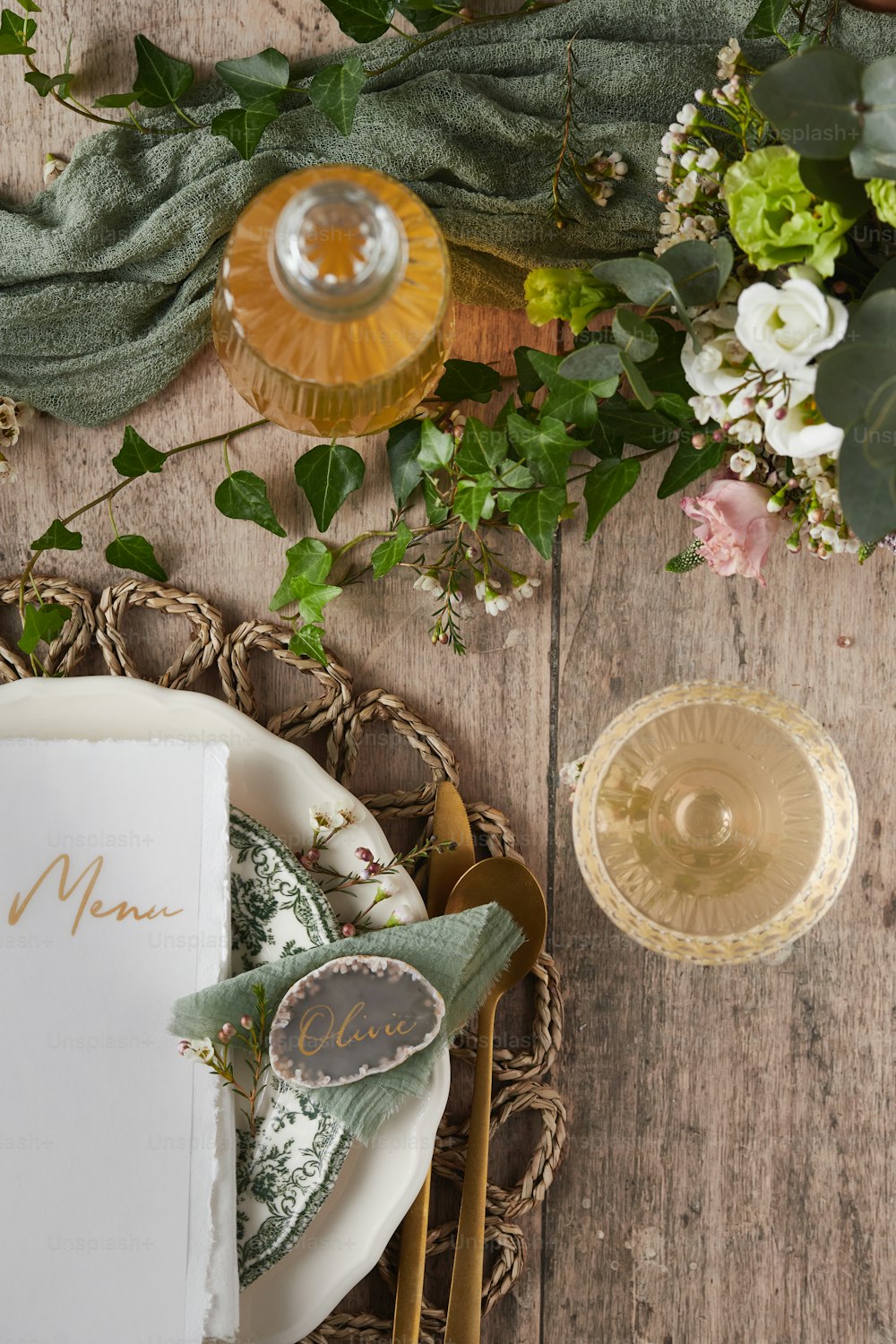 a place setting with a menu and flowers
