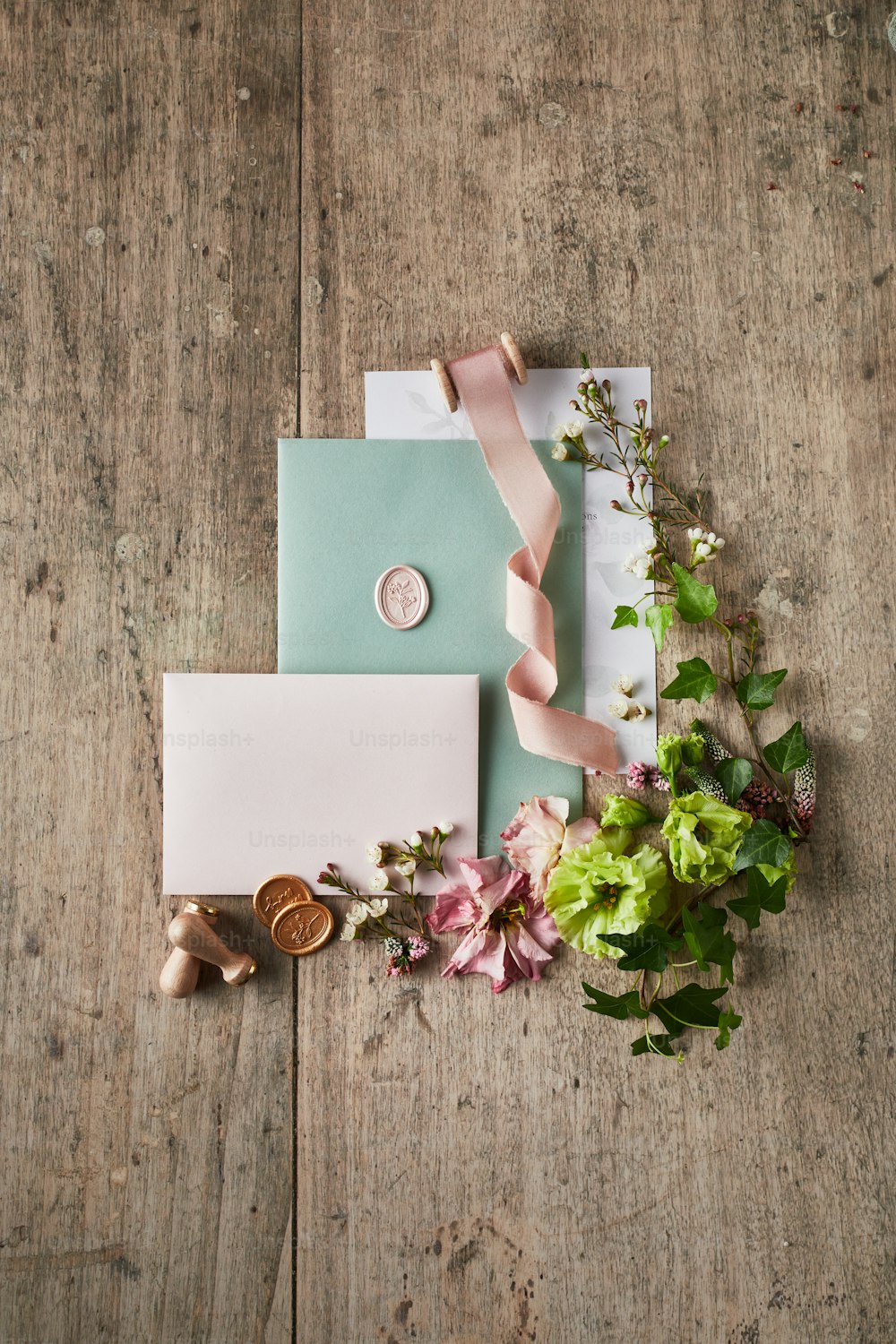 a bouquet of flowers sitting next to a wedding stationery