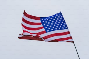 a large american flag flying in the sky