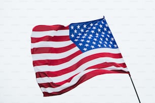 a large american flag flying in the wind