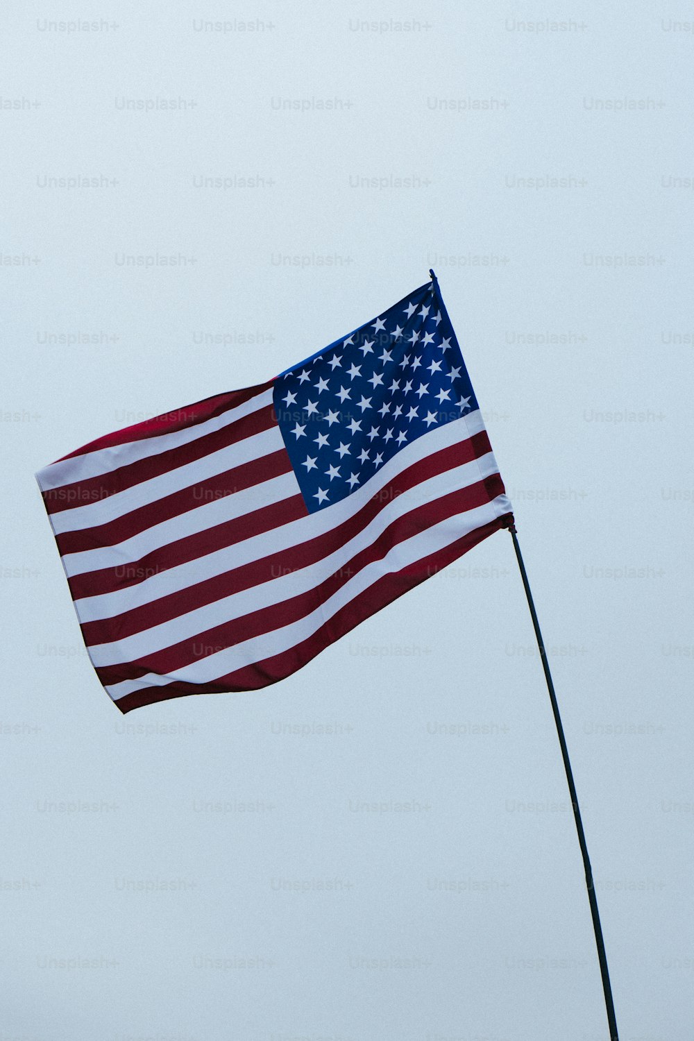a large american flag flying in the sky