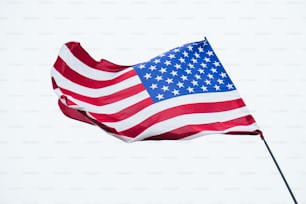 an american flag flying in the wind