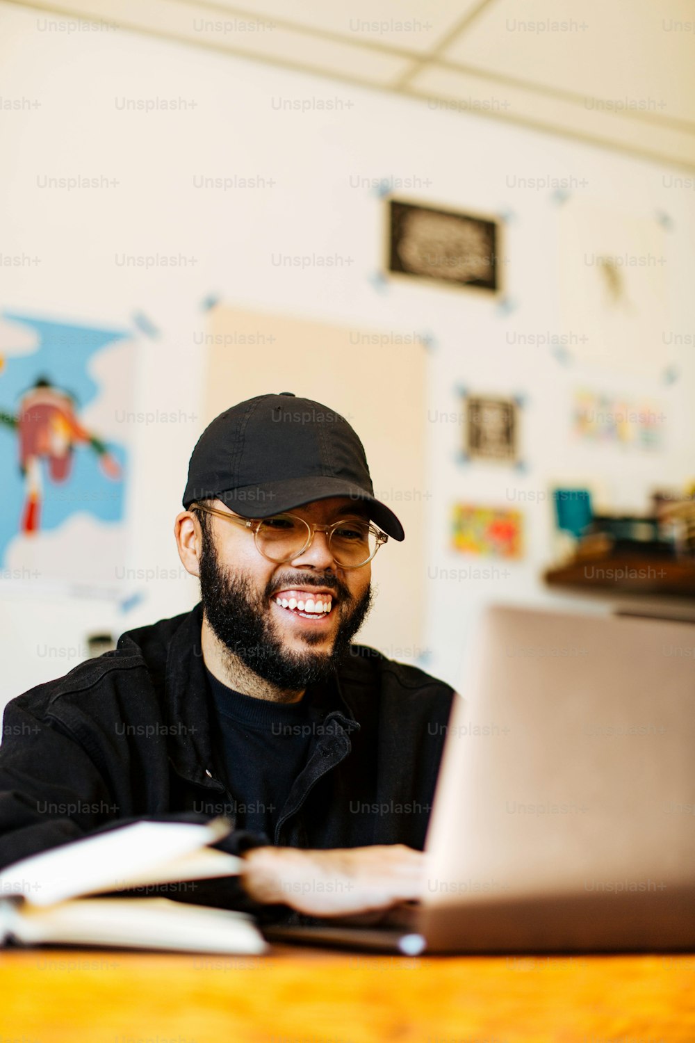 a man sitting at a table with a laptop