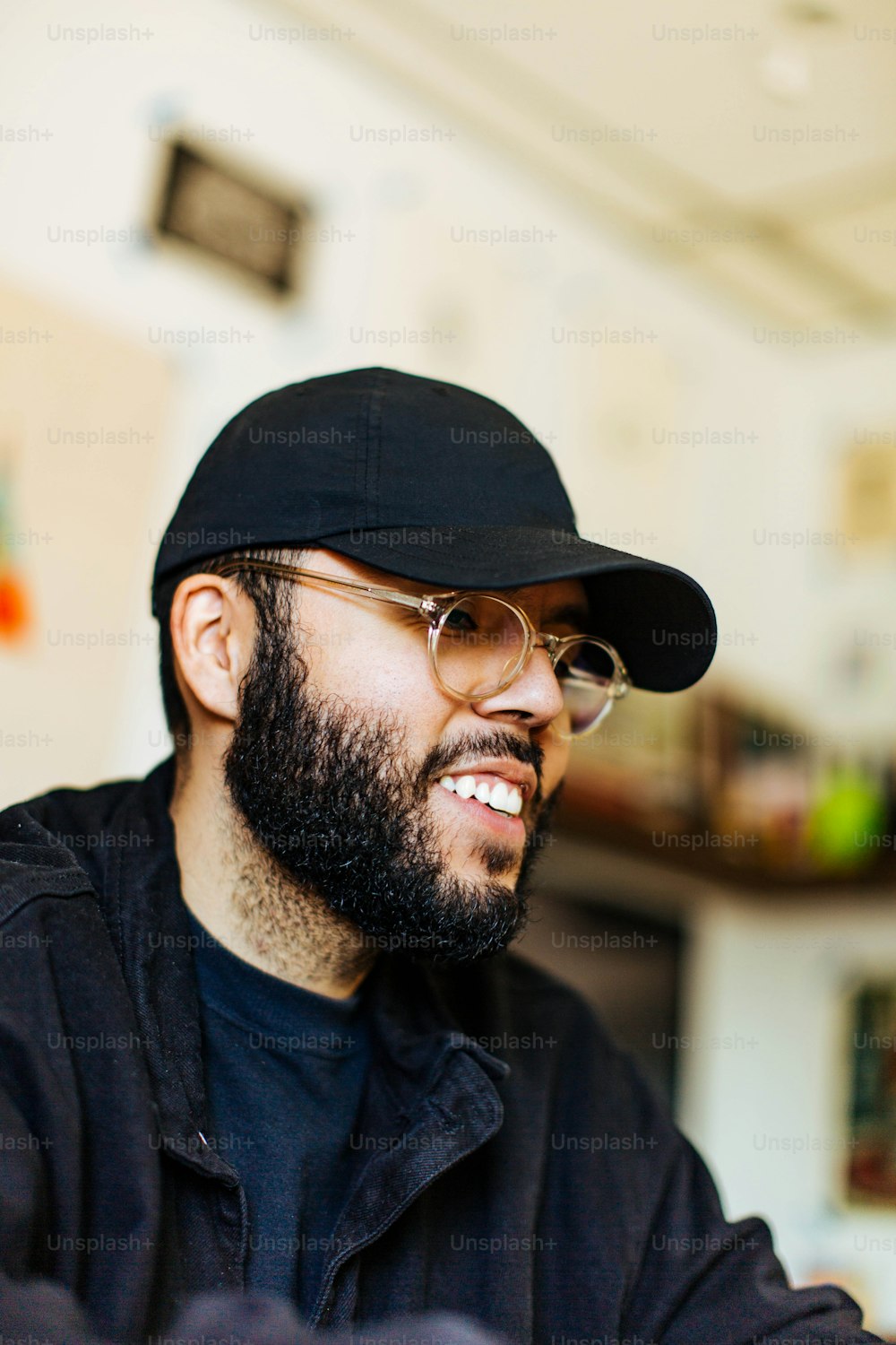 a man with a beard wearing a black hat