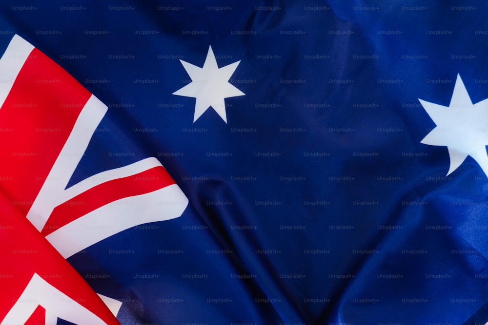 a close up of two flags of the united kingdom and australia