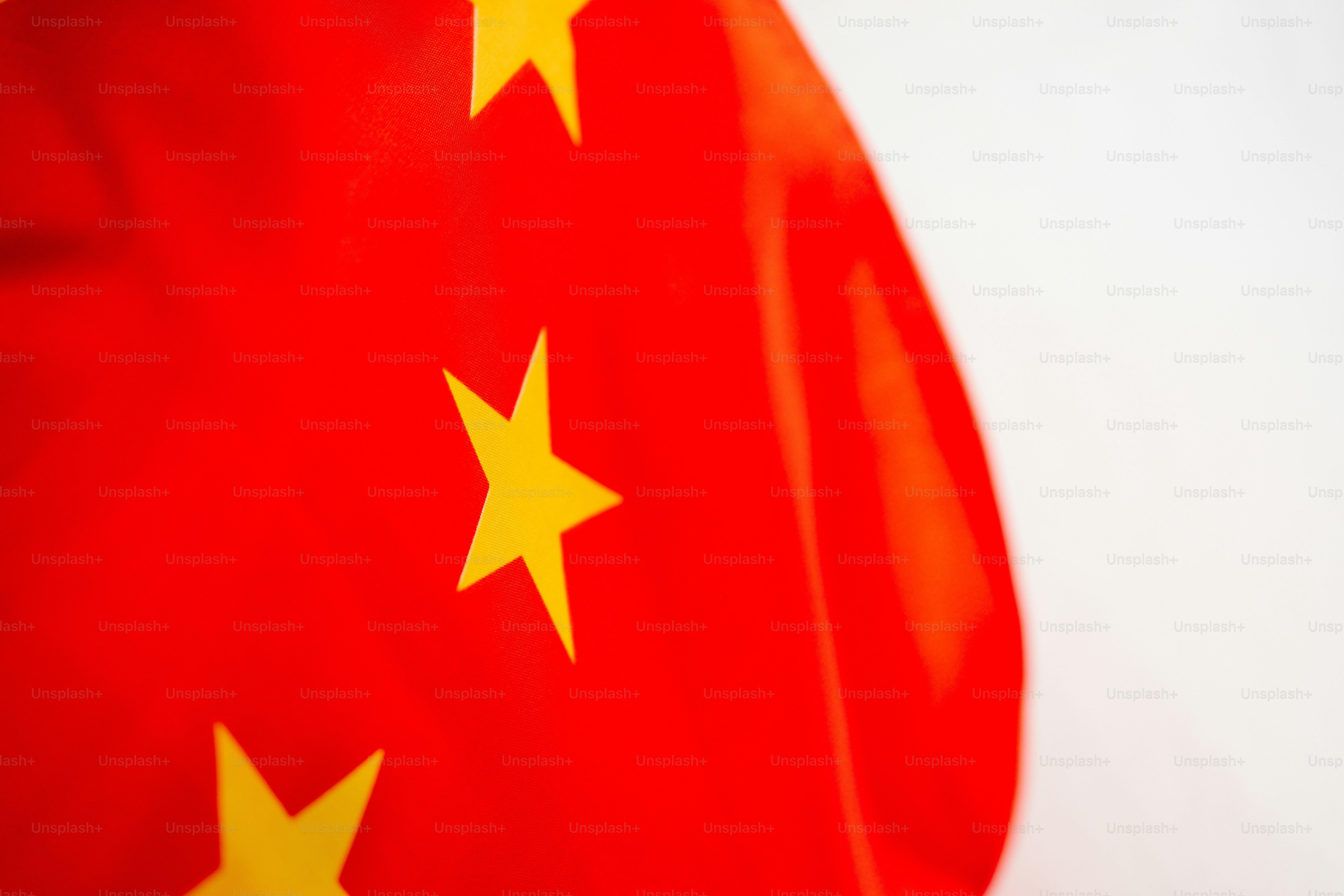 a red and yellow flag with yellow stars