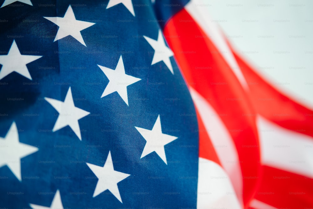 a close up of an american flag with red, white and blue stars