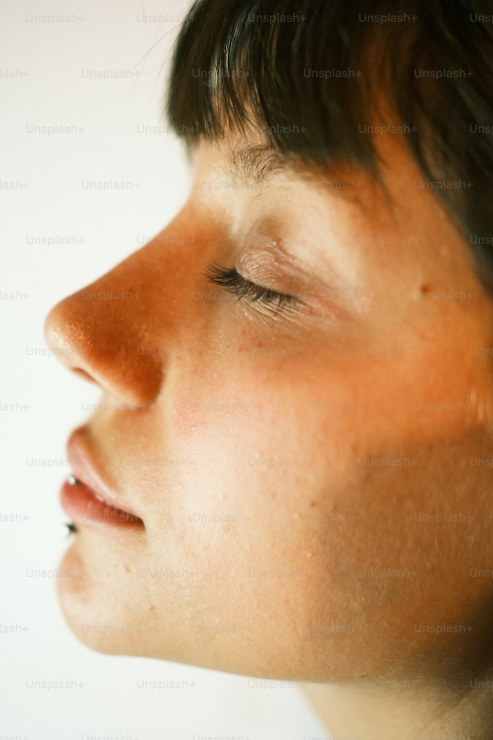 a close up of a person with their eyes closed