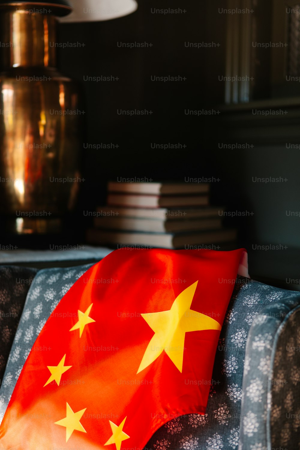 a red and yellow flag sitting on top of a couch