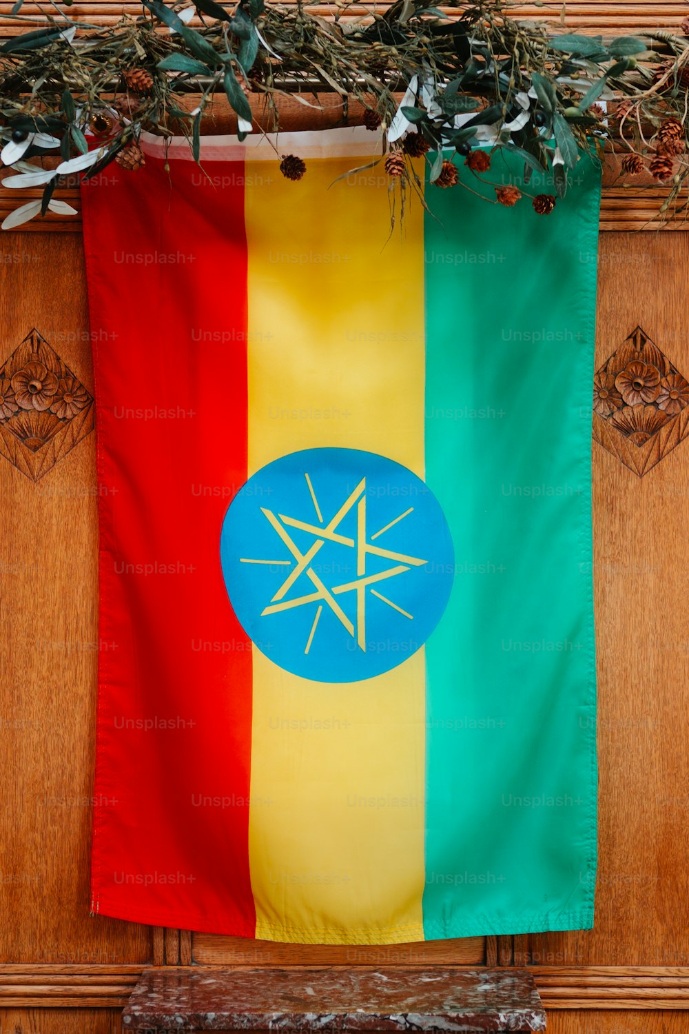 a flag hanging on a wooden door with a star on it