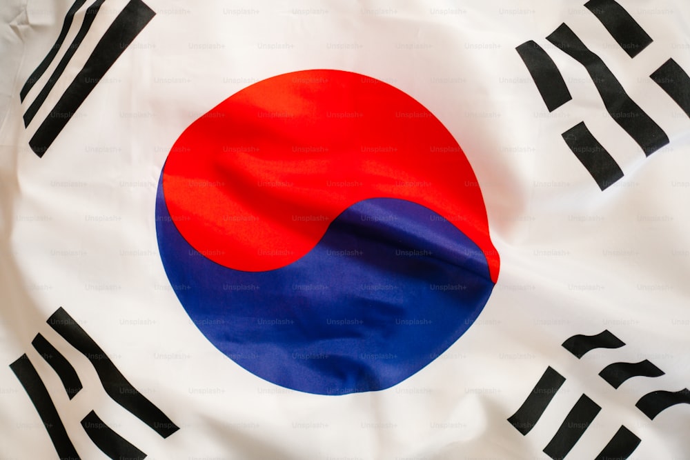 a close up of a flag with a red, white, and blue circle