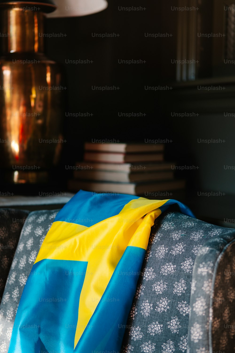 a blue and yellow blanket sitting on top of a couch
