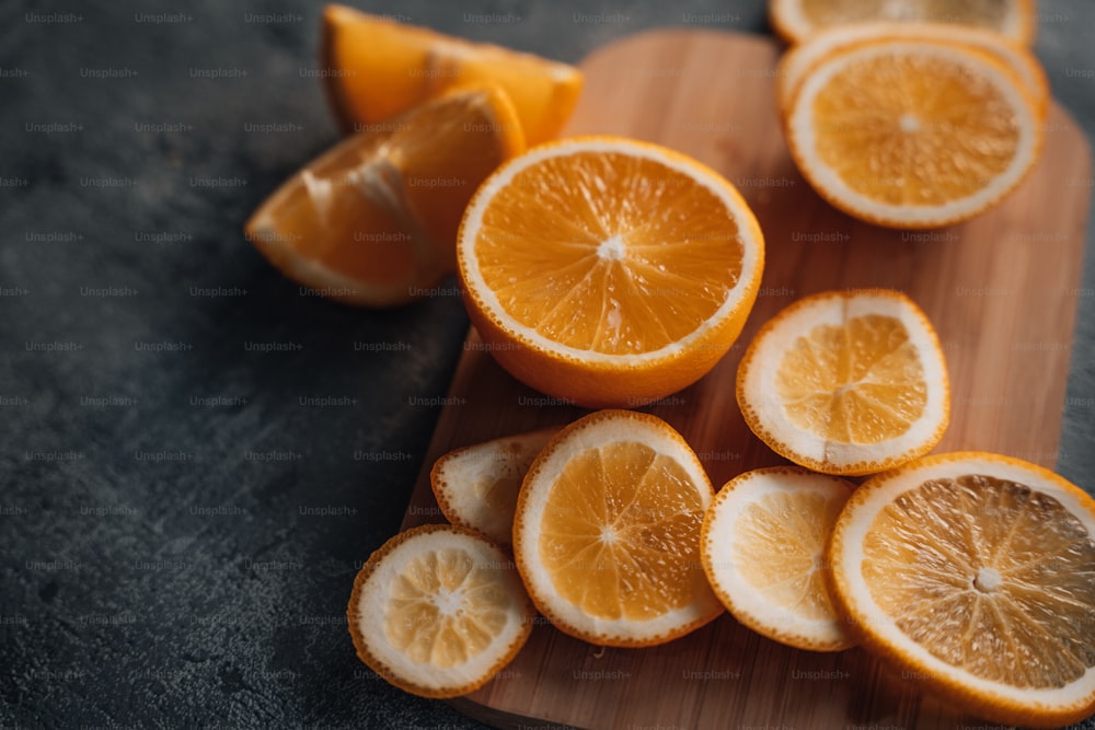 a wooden cutting board topped with sliced oranges