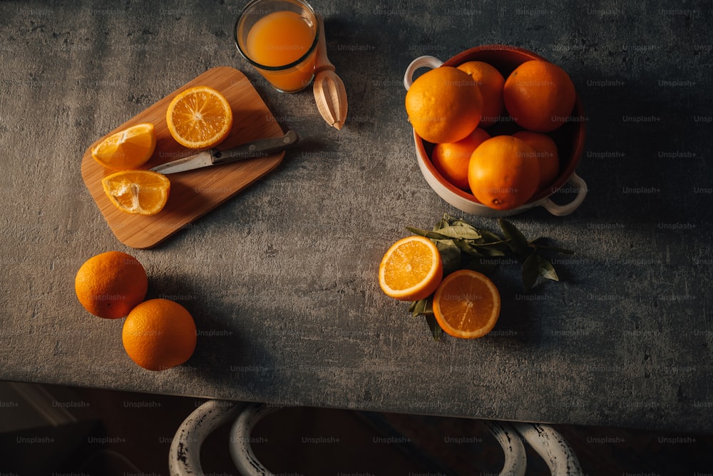 a bowl of oranges sitting on top of a table