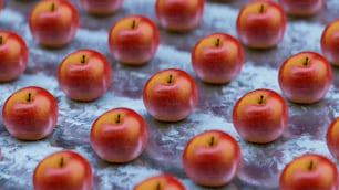 a bunch of red apples sitting on top of a table