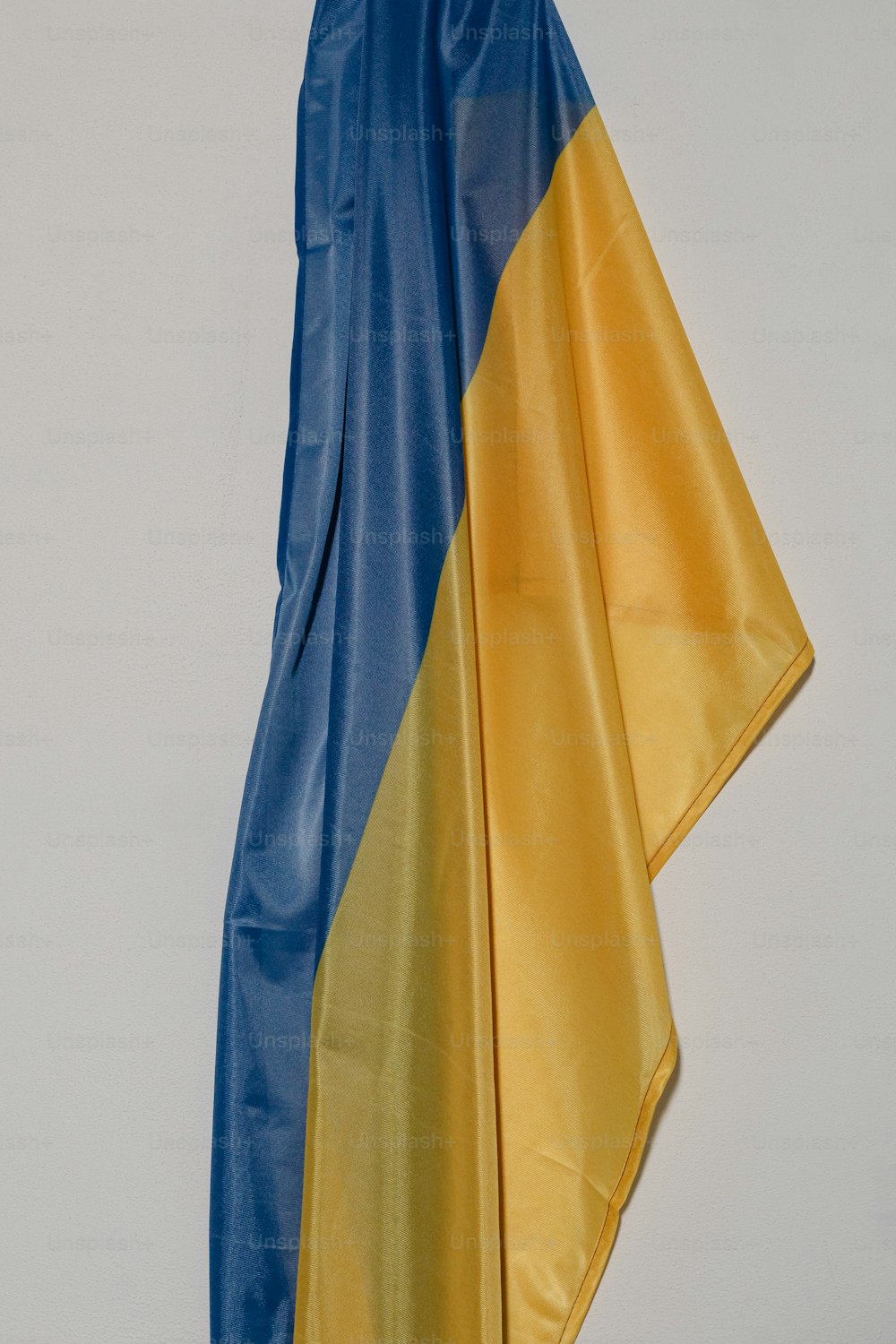 a blue and yellow flag hanging on a wall