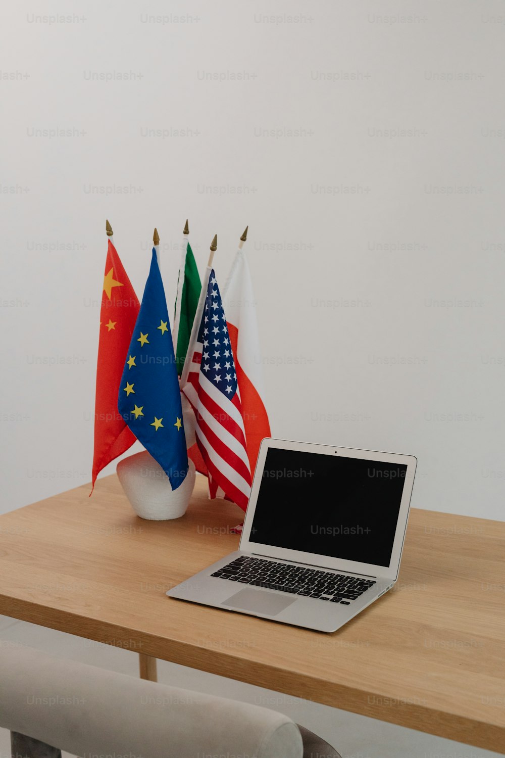 a laptop computer sitting on top of a wooden table