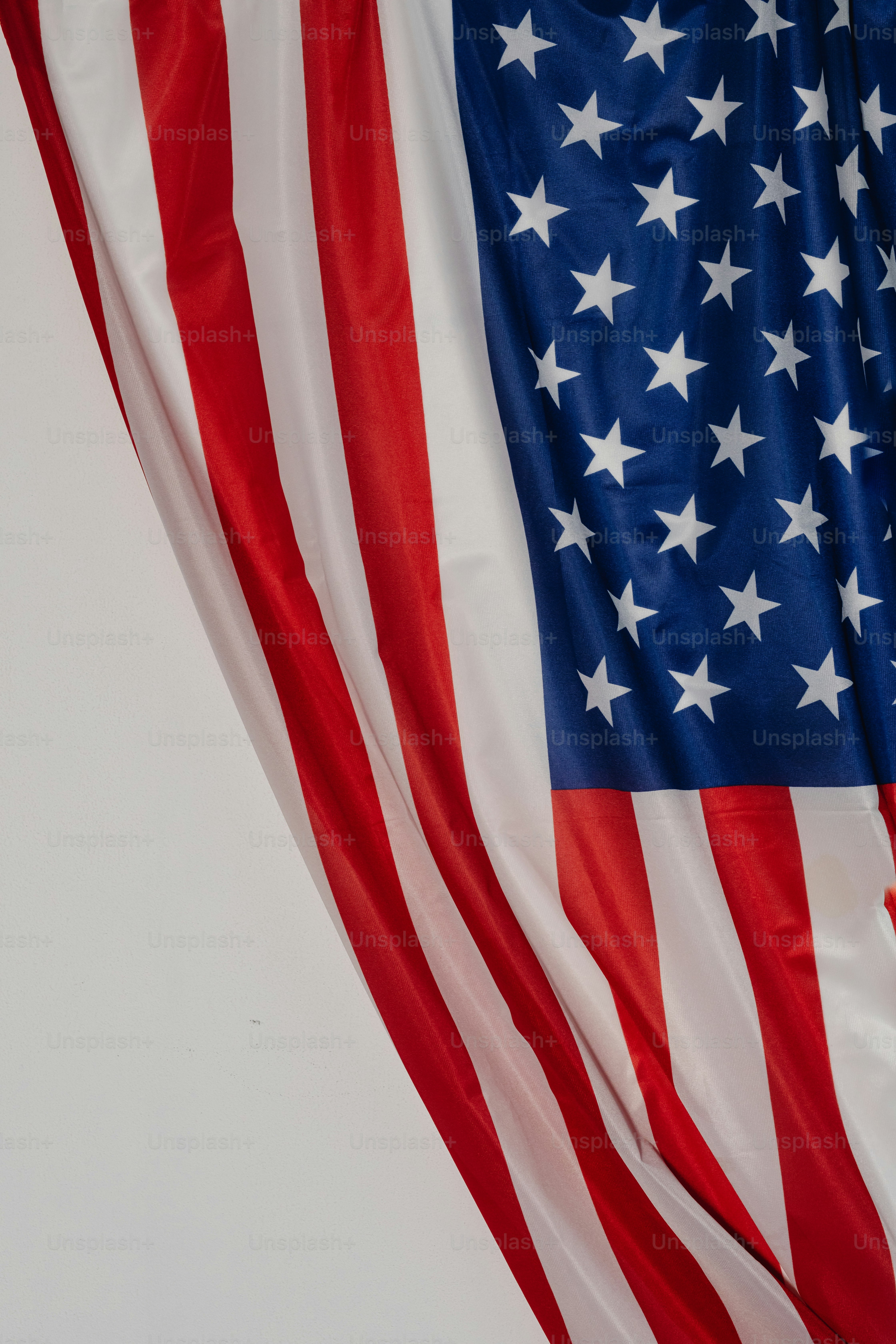 the american flag is flying in the wind