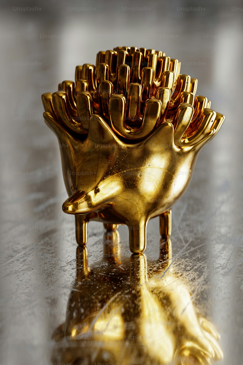 a golden object sitting on top of a shiny surface