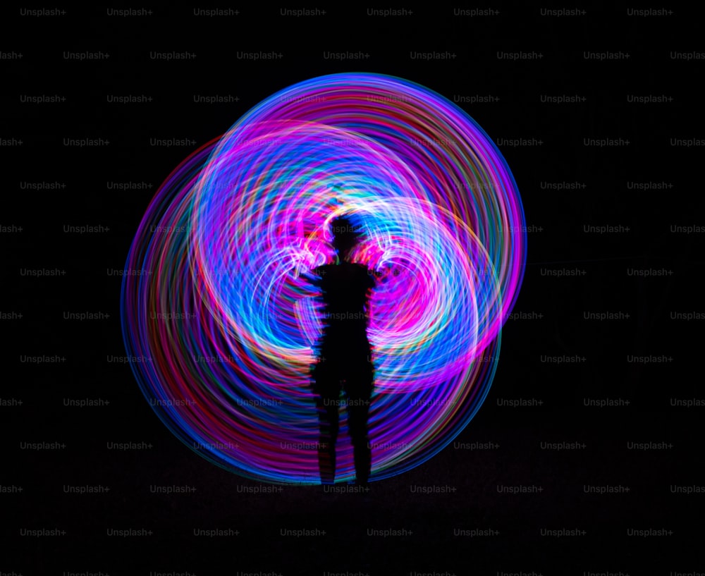 a person standing in the dark with a light painting