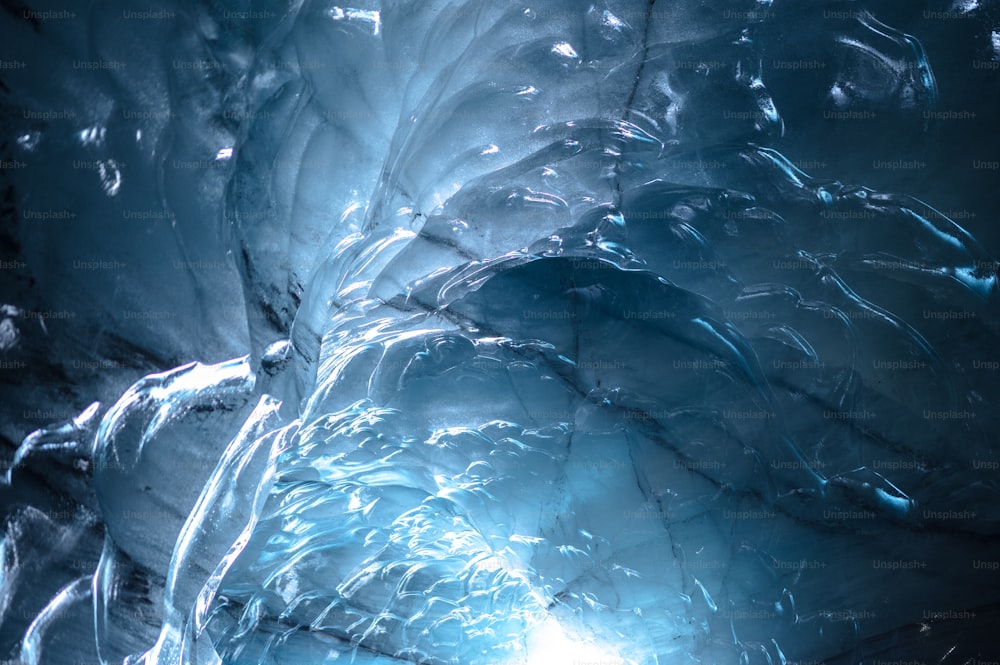 a large ice cave with a bright light coming from it