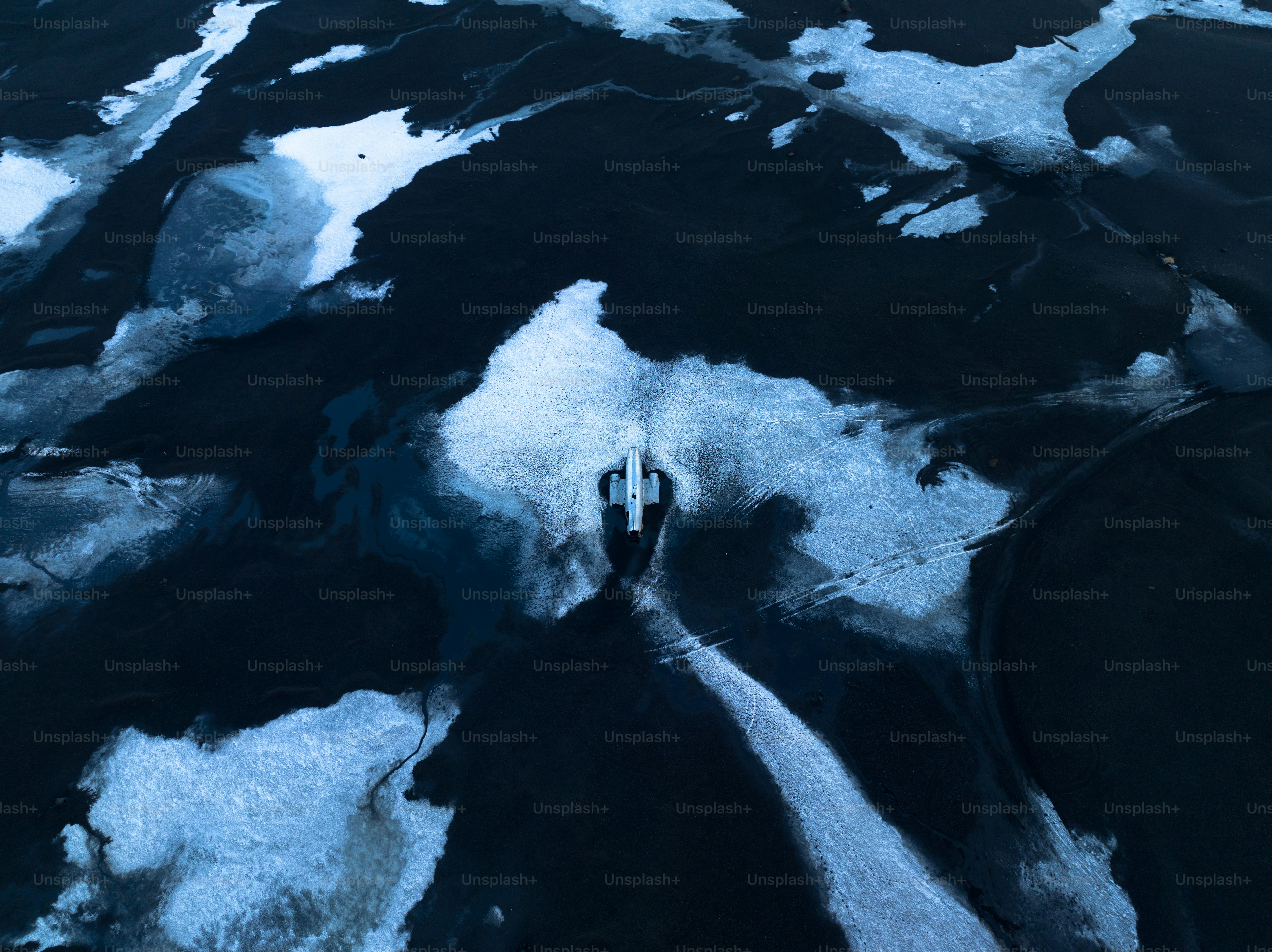 an aerial view of the water and ice