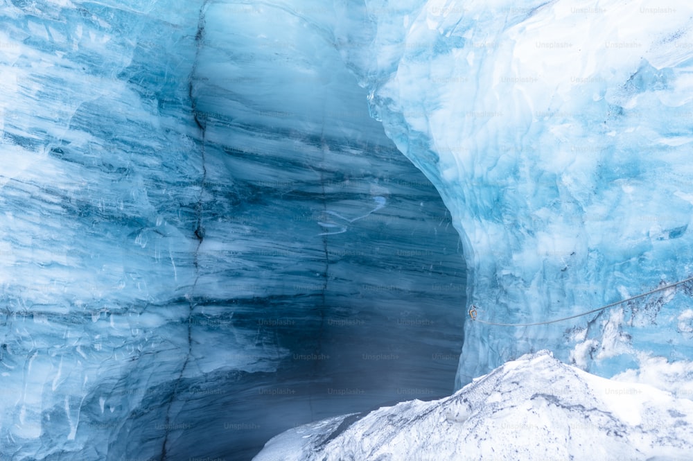 a man standing inside of an ice cave
