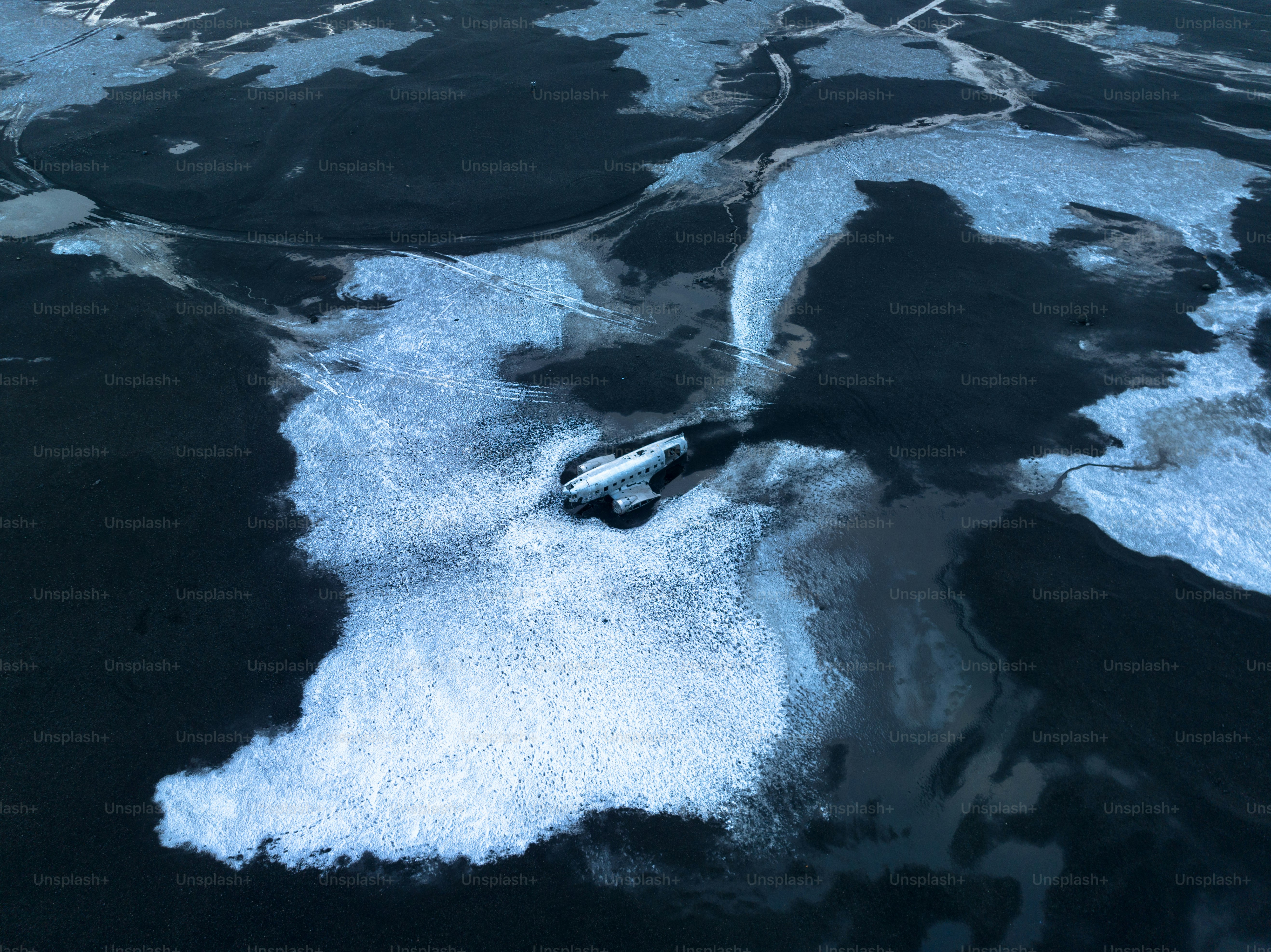 an aerial view of a boat in a body of water