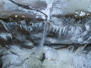 a fire hydrant spewing water out of a hole