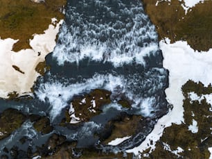 an aerial view of a body of water surrounded by snow