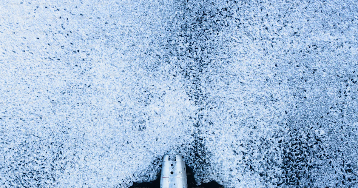 An aerial view of a jet flying over the ocean photo – Us navy Image on ...