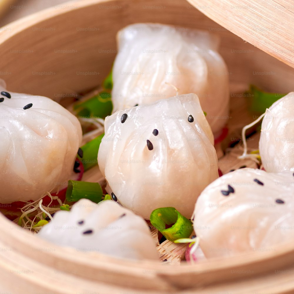 a close up of a bowl of food with dumplings