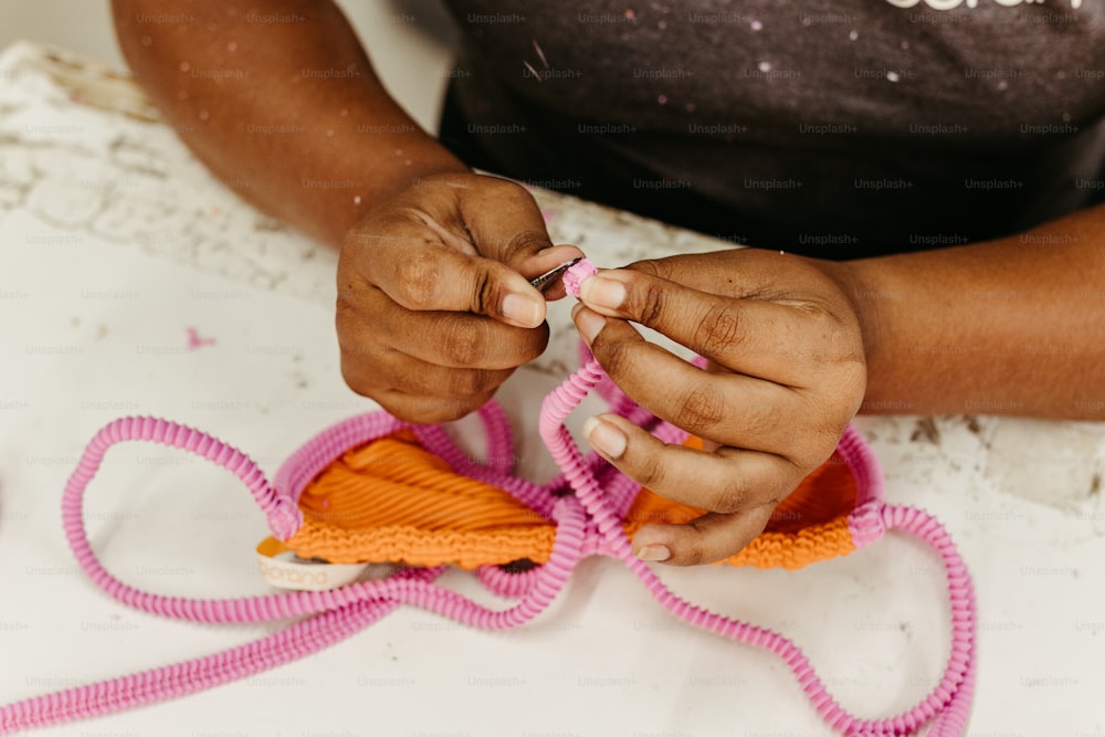 a woman is working on a pair of scissors
