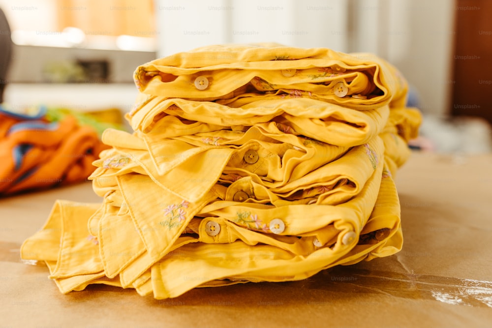 a pile of yellow cloth sitting on top of a table