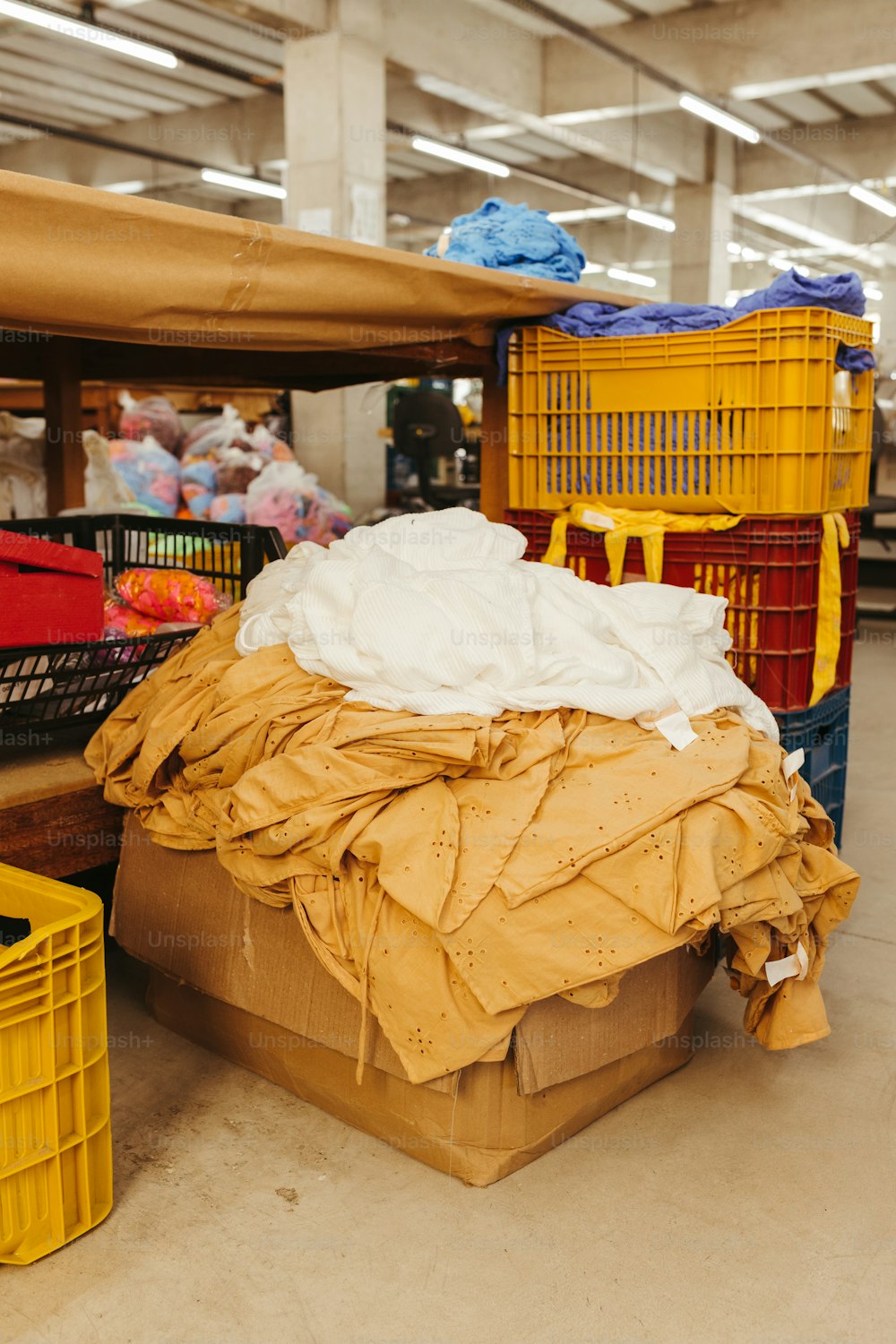 a large pile of clothes sitting on top of a floor