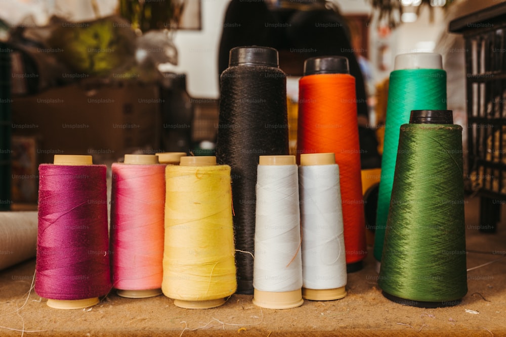 a group of spools of thread sitting on top of a table