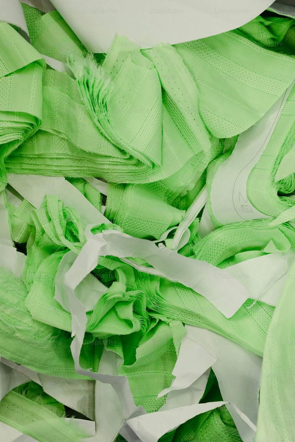 a pile of green and white tissue paper