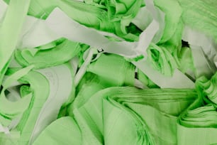 a close up of a pile of green shoes