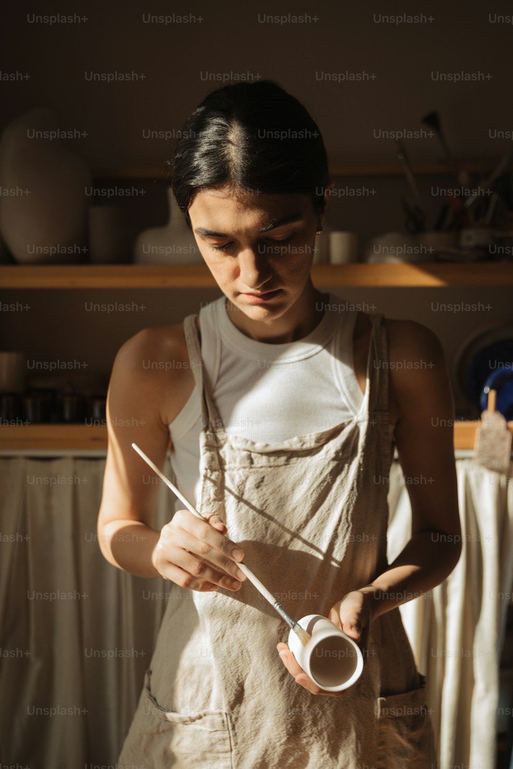 a man in an apron holding a pair of scissors