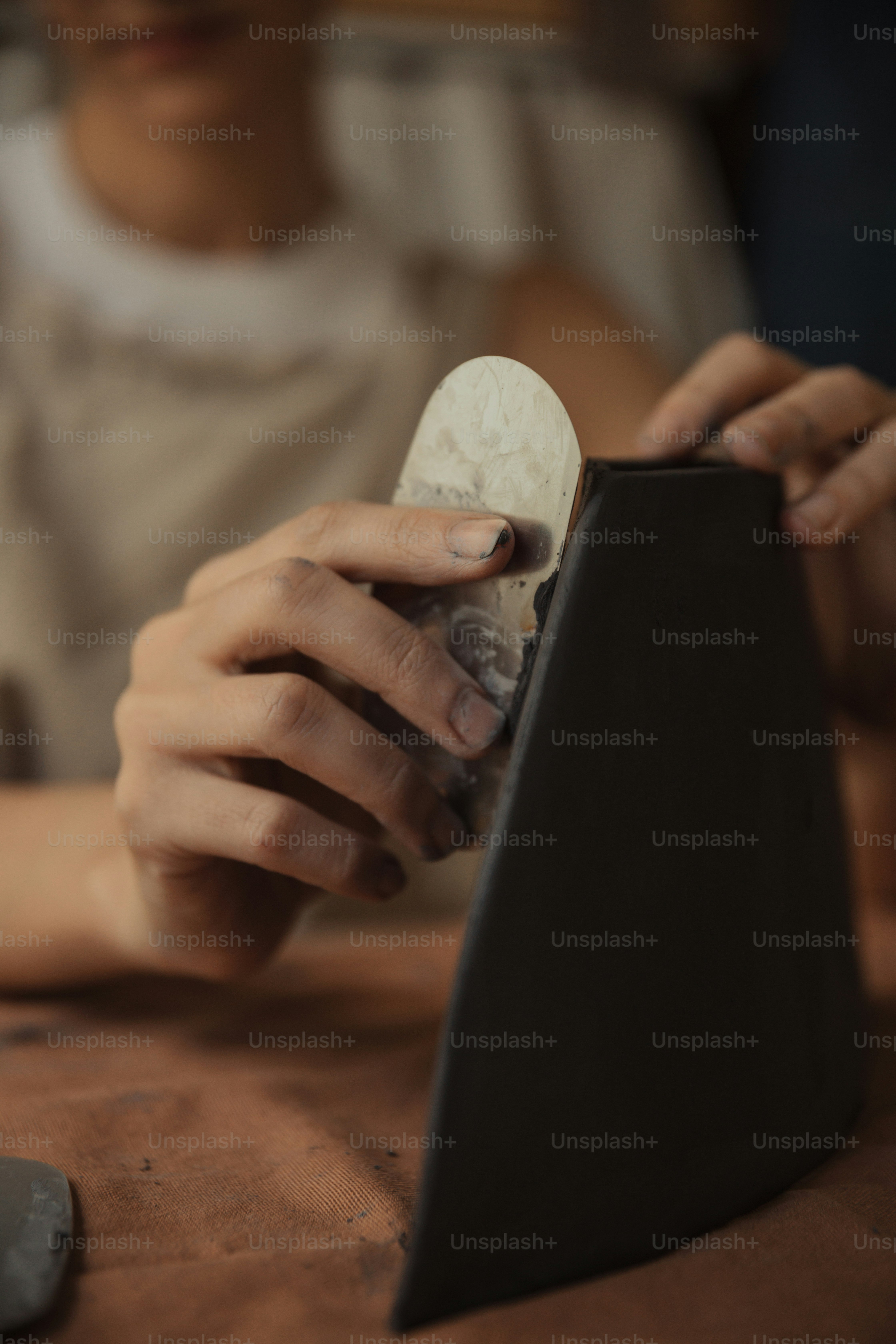 A person holding a small object in their hand photo – Pot throwing ...